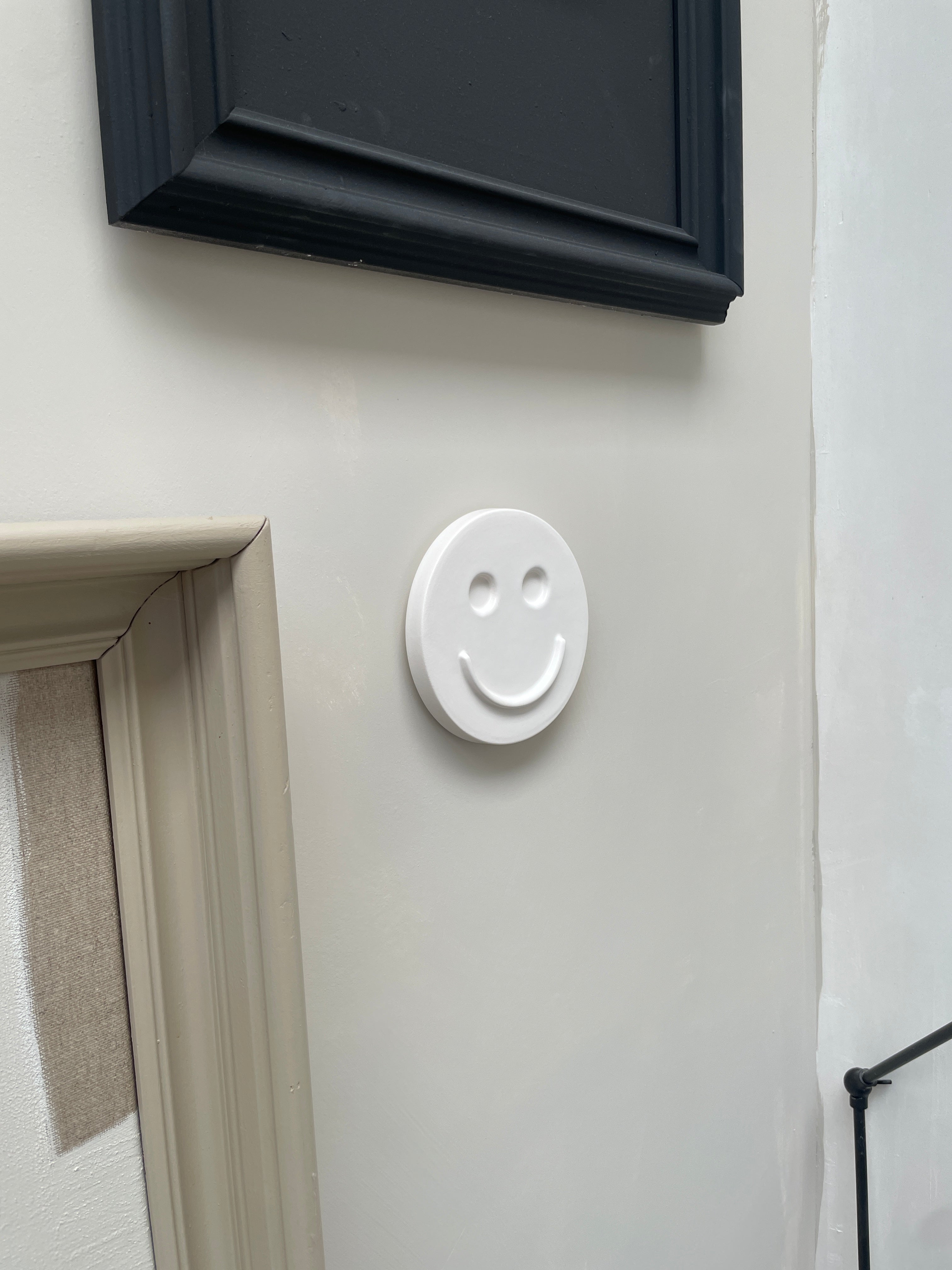 White 'HAPPY' ceramic artwork