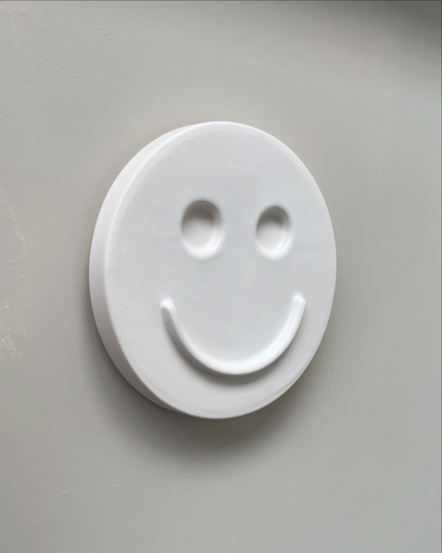 White 'HAPPY' ceramic artwork